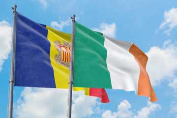 Ireland and Andorra flags waving in the wind against white cloudy blue sky together. Diplomacy concept, international relations.