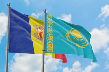 Kazakhstan and Andorra flags waving in the wind against white cloudy blue sky together. Diplomacy concept, international relations.