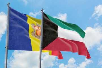 Kuwait and Andorra flags waving in the wind against white cloudy blue sky together. Diplomacy concept, international relations.