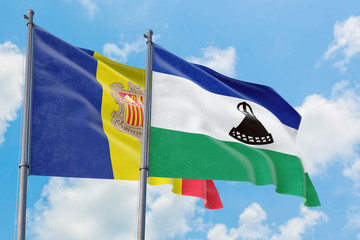 Lesotho and Andorra flags waving in the wind against white cloudy blue sky together. Diplomacy...