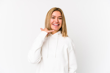 Young blonde caucasian woman isolated showing a mobile phone call gesture with fingers.