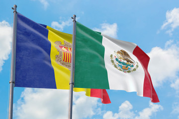 Mexico and Andorra flags waving in the wind against white cloudy blue sky together. Diplomacy concept, international relations.