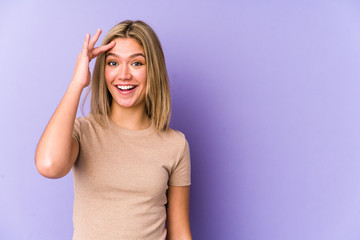 Fototapeta premium Young blonde caucasian woman isolated shouts loud, keeps eyes opened and hands tense.