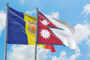 Nepal and Andorra flags waving in the wind against white cloudy blue sky together. Diplomacy concept, international relations.