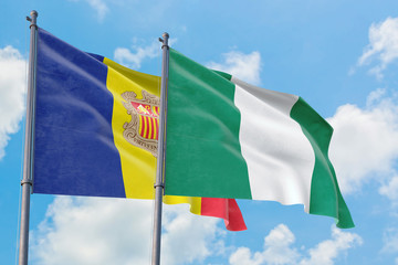 Nigeria and Andorra flags waving in the wind against white cloudy blue sky together. Diplomacy concept, international relations.