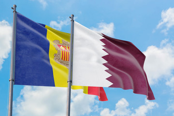 Qatar and Andorra flags waving in the wind against white cloudy blue sky together. Diplomacy concept, international relations.