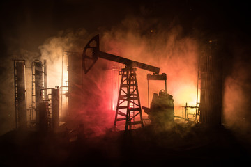 Artwork decoration. Oil pump and oil rig energy industrial machines for petroleum at night with fog...
