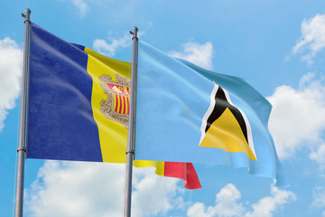 Saint Lucia and Andorra flags waving in the wind against white cloudy blue sky together. Diplomacy concept, international relations.