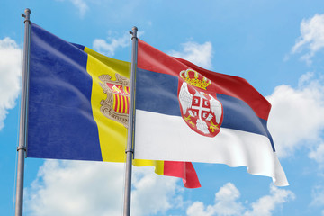 Serbia and Andorra flags waving in the wind against white cloudy blue sky together. Diplomacy concept, international relations.