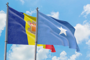 Somalia and Andorra flags waving in the wind against white cloudy blue sky together. Diplomacy concept, international relations.