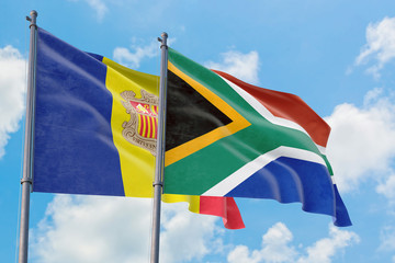 South Africa and Andorra flags waving in the wind against white cloudy blue sky together. Diplomacy concept, international relations.