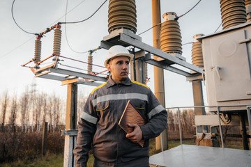 The energy engineer inspects the equipment of the substation. Power engineering. Industry