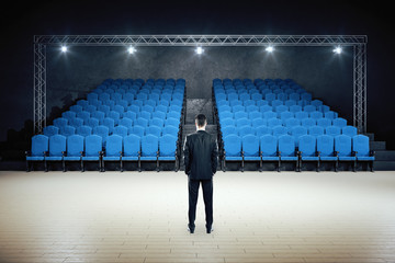 Businessman standing in minimalistic movie theater