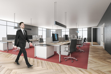 Businessman in modern office interior with furniture.