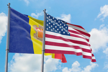 United States and Andorra flags waving in the wind against white cloudy blue sky together. Diplomacy concept, international relations.