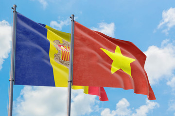 Vietnam and Andorra flags waving in the wind against white cloudy blue sky together. Diplomacy concept, international relations.