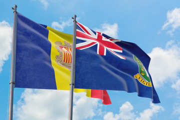 British Virgin Islands and Andorra flags waving in the wind against white cloudy blue sky together. Diplomacy concept, international relations.