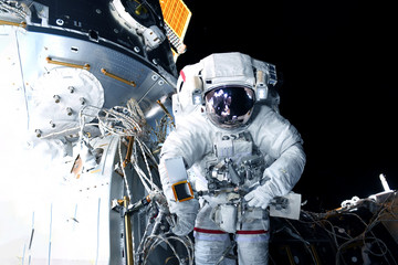Naklejka premium Astronaut in outer space at the space station. Elements of this image were furnished by NASA.
