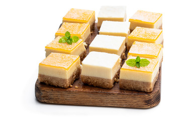 Set of mini lemon and vanilla cheesecake bites isolated on white