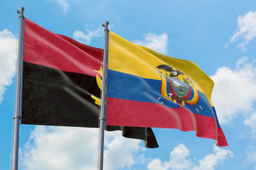 Ecuador and Angola flags waving in the wind against white cloudy blue sky together. Diplomacy concept, international relations.