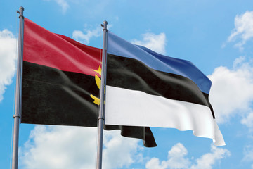 Estonia and Angola flags waving in the wind against white cloudy blue sky together. Diplomacy concept, international relations.