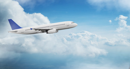 Commercial airplane jetliner flying above dramatic clouds in beautiful light. Travel concept.