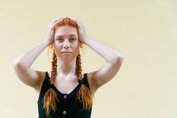 Beautiful restless girl holding her head. Turmoil and fuss concept with copyspace.