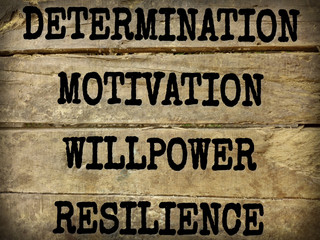 inspirational and motivational words of determination motivation willpower resilience on plank wood with vintage background