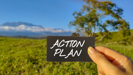inspirational and motivational text of action plan written on paper with nature background