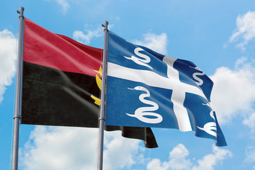 Martinique and Angola flags waving in the wind against white cloudy blue sky together. Diplomacy...