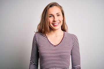 Young beautiful blonde woman wearing casual striped t-shirt over isolated white background with a happy and cool smile on face. Lucky person.