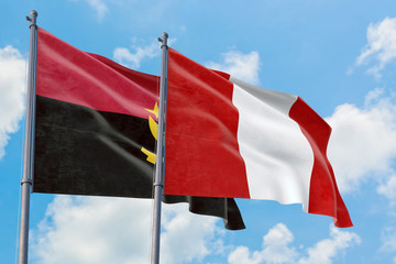 Peru and Angola flags waving in the wind against white cloudy blue sky together. Diplomacy concept,...