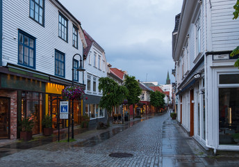STAVANGER, NORWAY, july, 2019 : street with Traditional wooden houses in Gamle Stavanger. Gamle Stavanger is a historic area of the city center of Stavanger. Rainy moody day. Travel and