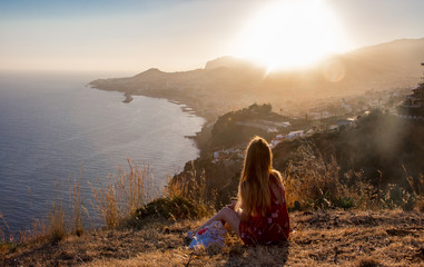 Sunset view person hiking madeira miradouro looking over bay of Funchal outdoor traveling concept