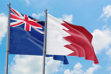 Bahrain and Anguilla flags waving in the wind against white cloudy blue sky together. Diplomacy concept, international relations.