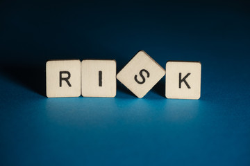 Risk: square wooden letters on a blue background