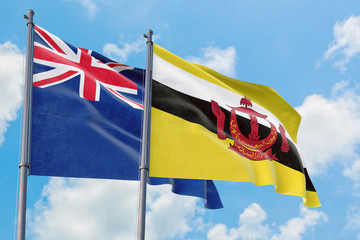 Brunei and Anguilla flags waving in the wind against white cloudy blue sky together. Diplomacy concept, international relations.