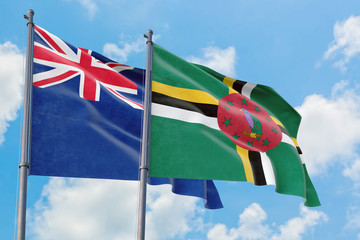 Dominica and Anguilla flags waving in the wind against white cloudy blue sky together. Diplomacy concept, international relations.