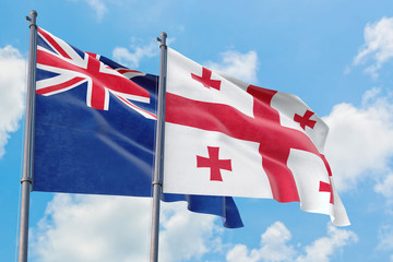 Georgia and Anguilla flags waving in the wind against white cloudy blue sky together. Diplomacy concept, international relations.