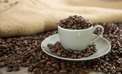 Roasted coffee beans in a coffee mug