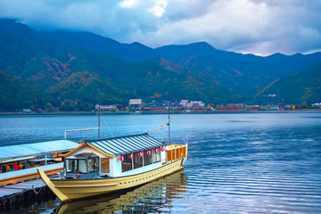Japan. The boat is moored in the lake Kawaguchiko. Japanese-style boat stands at the pier. Walks on the lake Kawaguchiko by boat. Autumn Japan. Pier in the city of Fujikawaguchiko. Tour to Japan
