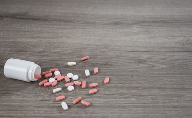 Some pills on wooden background