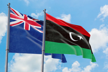Libya and Anguilla flags waving in the wind against white cloudy blue sky together. Diplomacy...