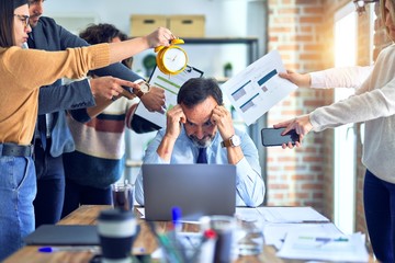 Group of business workers working together. Partners stressing one of them at the office