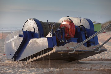 Industrial winch being towed in sand