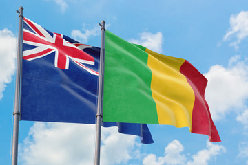 Mali and Anguilla flags waving in the wind against white cloudy blue sky together. Diplomacy concept, international relations.
