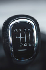 Close up of the manual gearbox transmission handle. Accelerator handle and buttons in a new car. Auto interior detail.