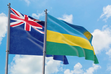 Rwanda and Anguilla flags waving in the wind against white cloudy blue sky together. Diplomacy concept, international relations.