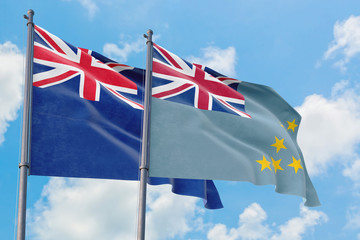 Tuvalu and Anguilla flags waving in the wind against white cloudy blue sky together. Diplomacy concept, international relations.