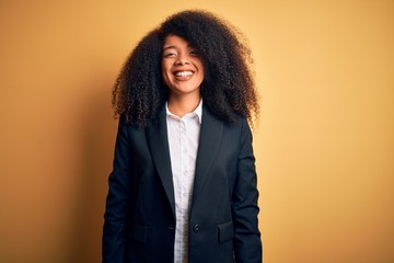 Young beautiful african american business woman with afro hair wearing elegant jacket with a happy and cool smile on face. Lucky person.